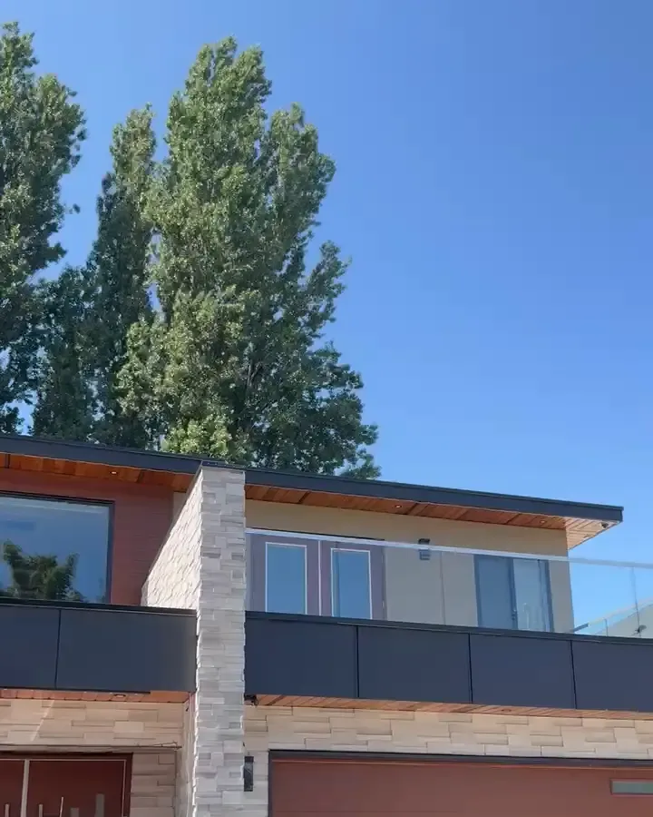 Our install on a modern two-storey home by day; the track is tucked under the roofline