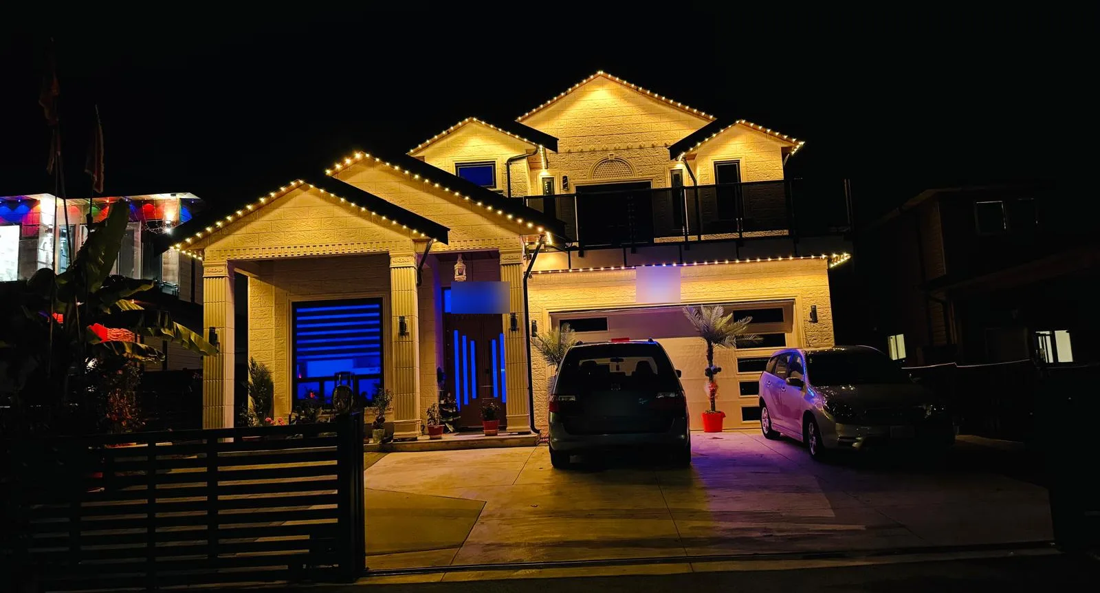 The same home with roofline lights in warm white